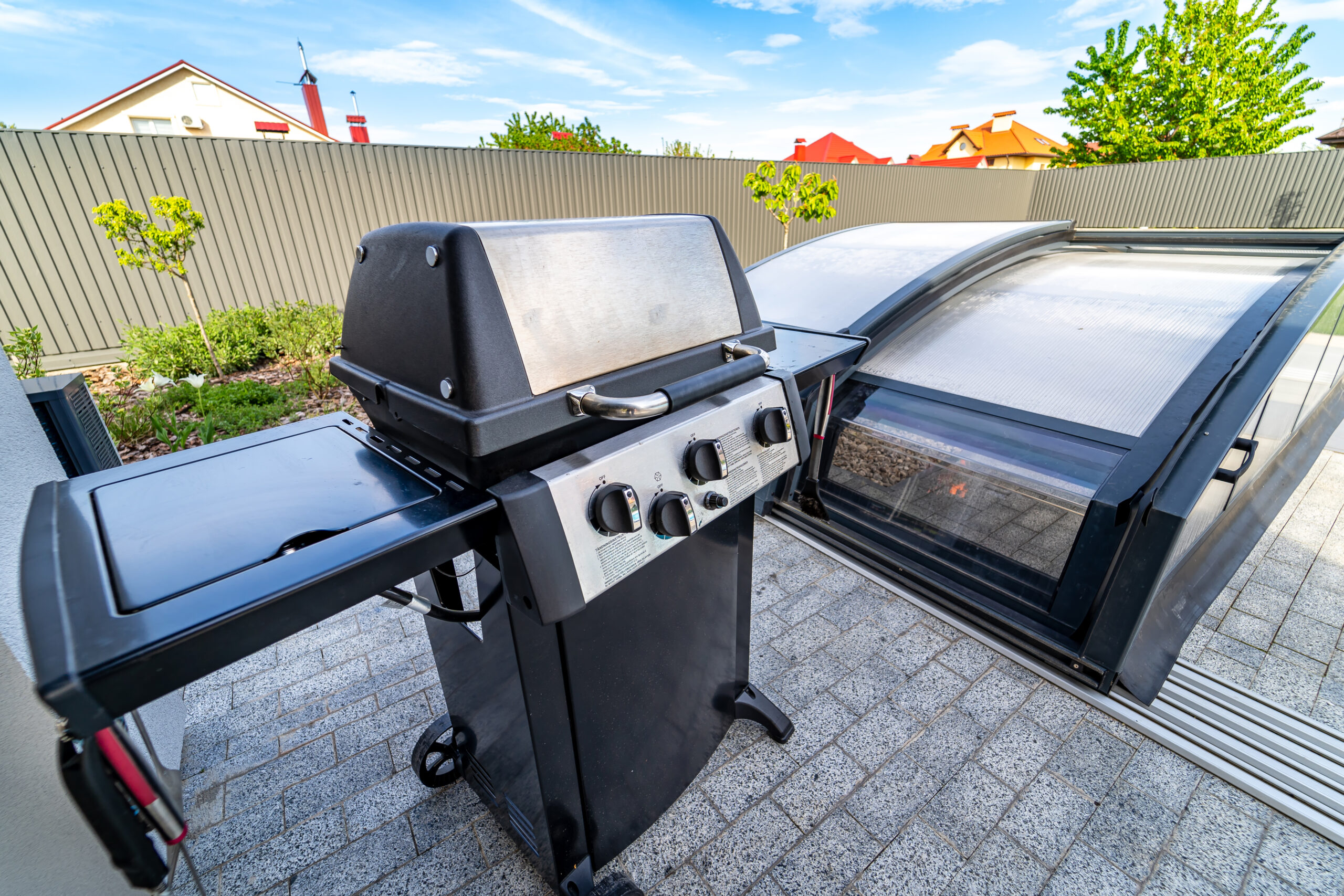 Modern outdoor gas grill with side shelves in a stylish backyard setting, showcasing a sleek design and durable materials, ideal for enhancing outdoor cooking experiences.