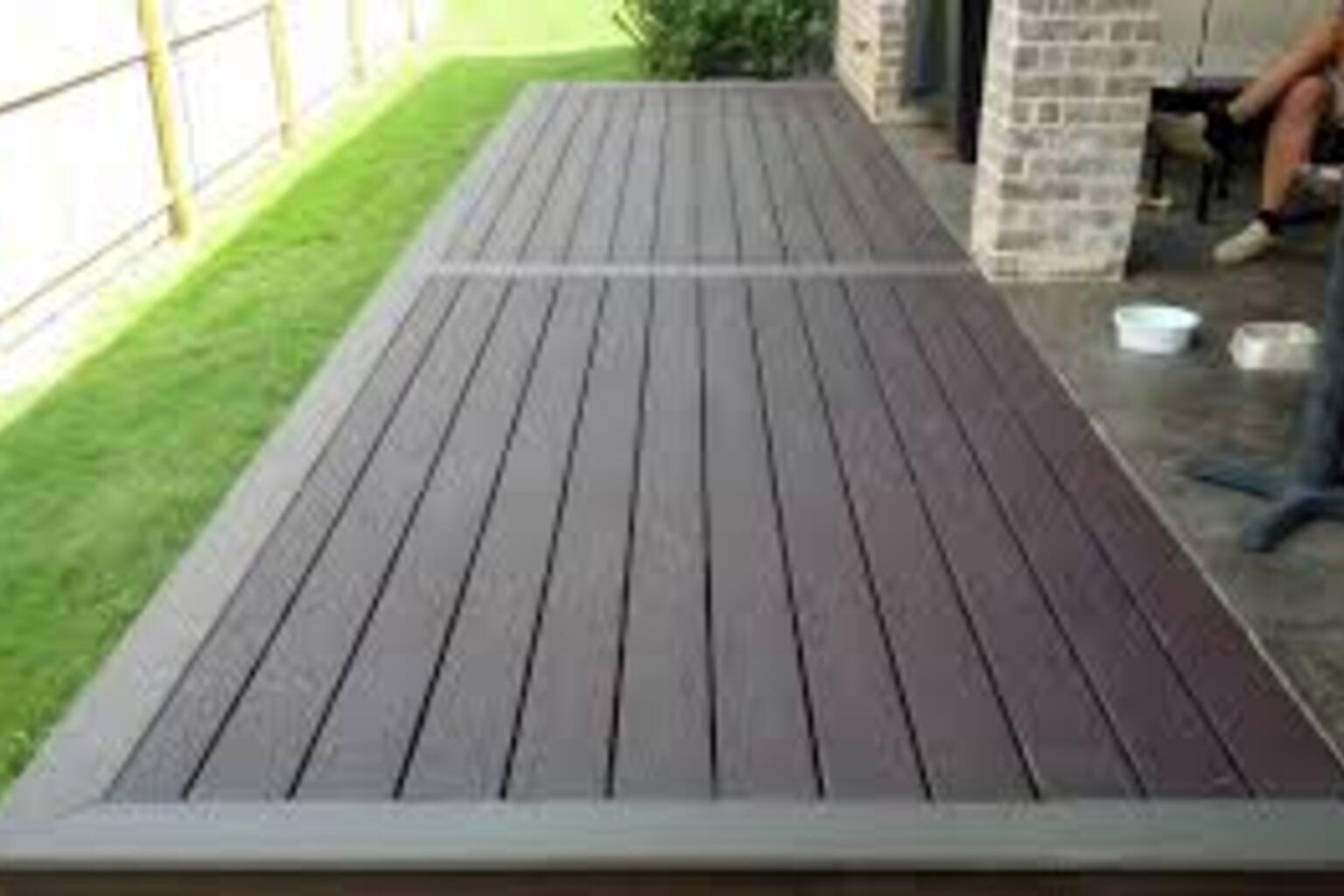 Composite decking surface with a seamless transition to a patio, showcasing low-maintenance, weather-resistant materials ideal for enhancing indoor-outdoor living spaces.
