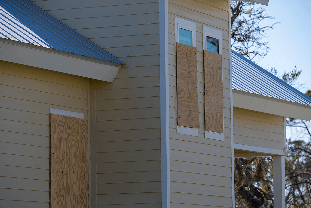 Exterior of a home featuring James Hardie fiber cement siding with plywood covering windows, showcasing durability and weather resistance suitable for Mississippi's climate.
