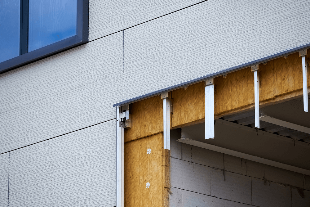 Insulated siding installation showcasing foam-backed panels and precision alignment, emphasizing energy efficiency and aesthetic appeal for home improvement in Oxford, MS.