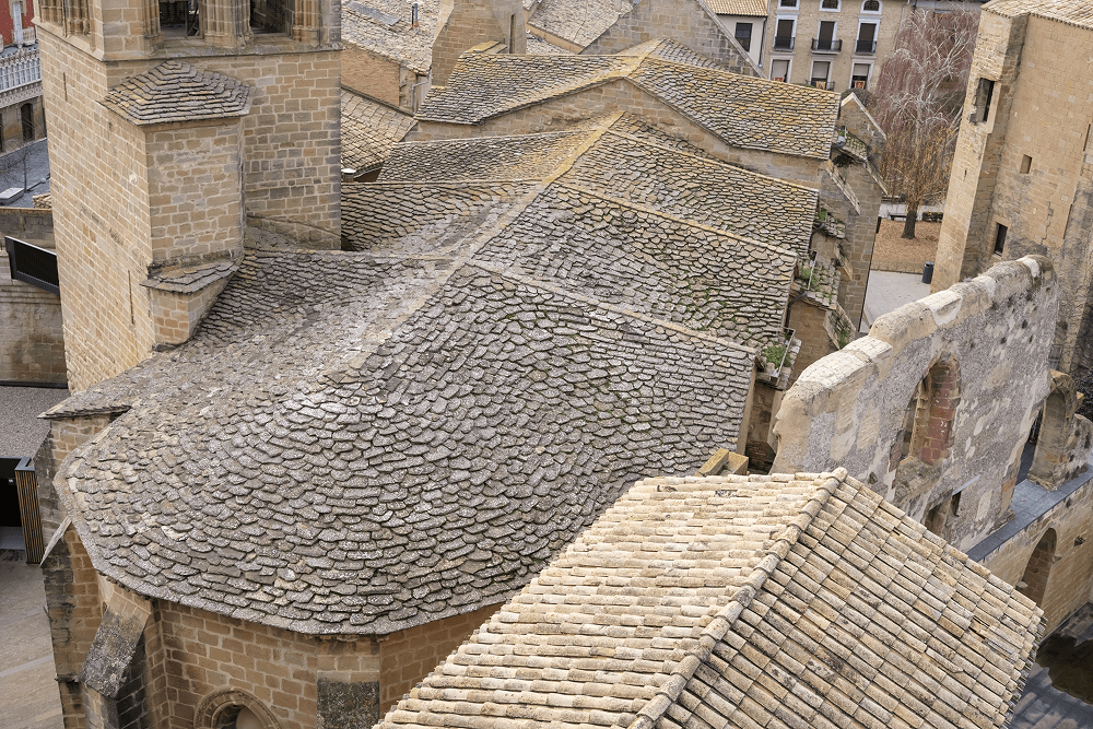 Roofing structures with textured stone tiles, showcasing craftsmanship and durability, relevant to exterior remodeling services by Tekton Exteriors Mississippi.